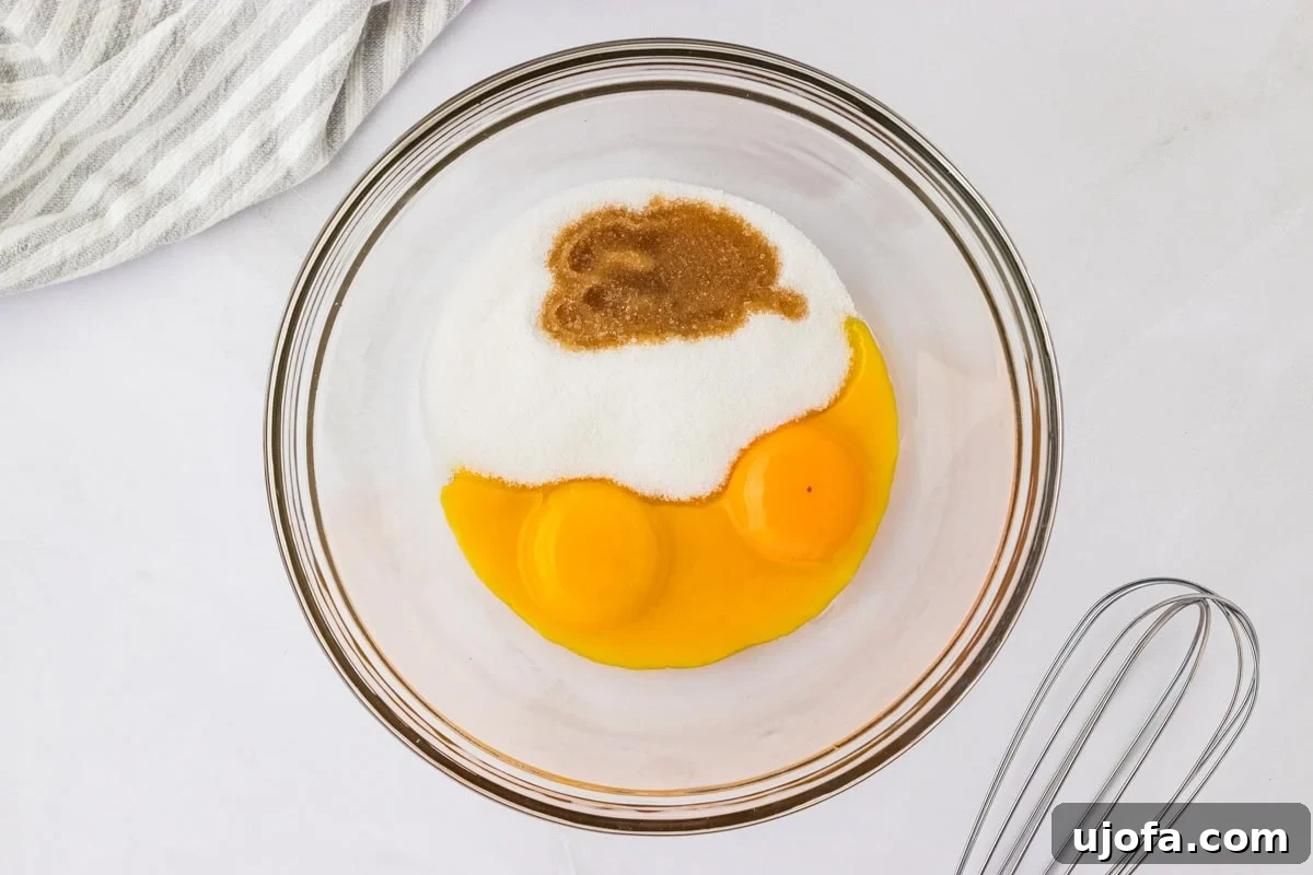 egg yolks, granulated sugar, and vanilla in a glass bowl