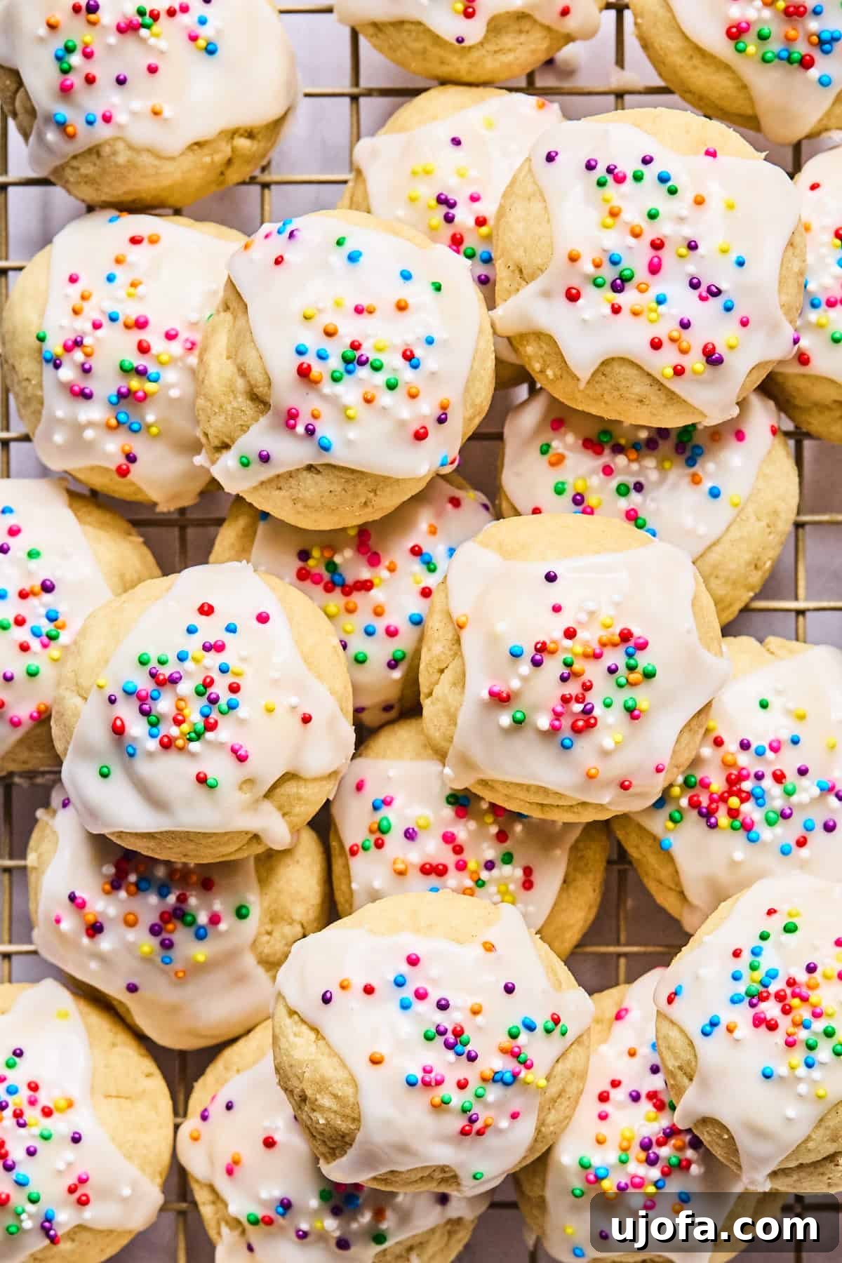 Sweet Traditions: Gluten-Free Italian Wedding Cookies 2 Close-up of gluten free Italian wedding cookies stacked on a wire cooling rack, glistening with almond glaze.