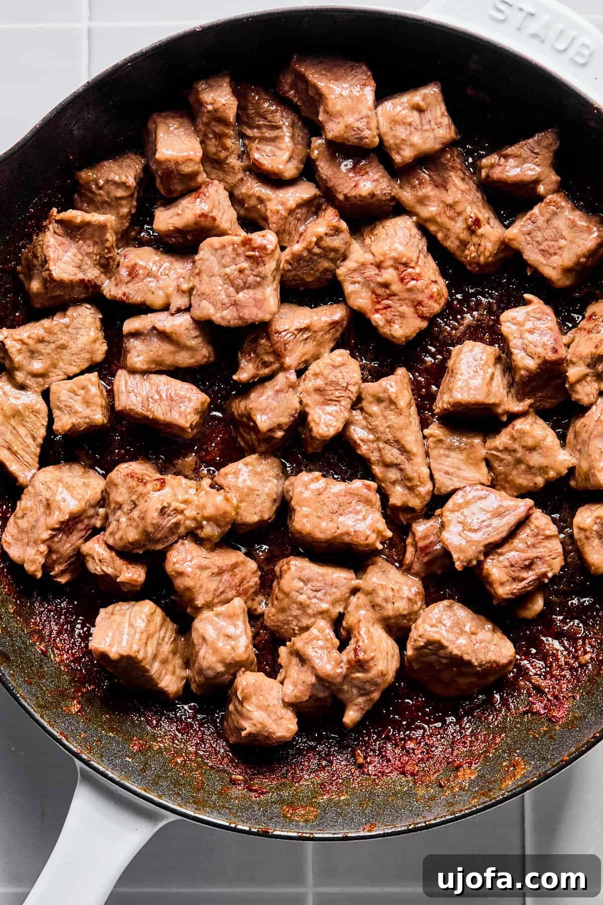 Set It and Forget It Hearty Beef Stew 5 Stew meat searing in a hot skillet, developing a golden-brown crust on all sides.