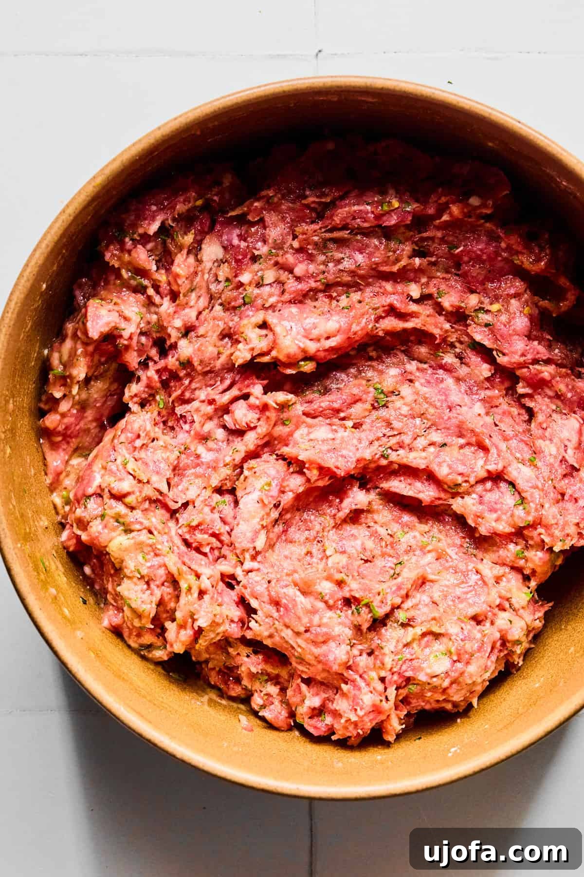 Meatball ingredients in a large bowl mixed together so that everything is evenly incorporated.