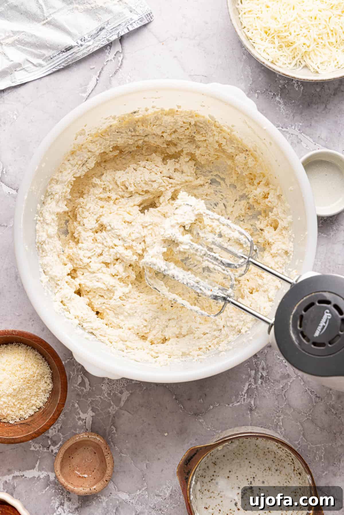 Ultimate Creamy Protein Pizza Dip 5 The smooth, fully blended high protein pizza dip base inside a white mixing bowl, achieved with an electric mixer, displaying a perfect, spreadable consistency without any visible cottage cheese curds. It's ready for the next stage of assembly.