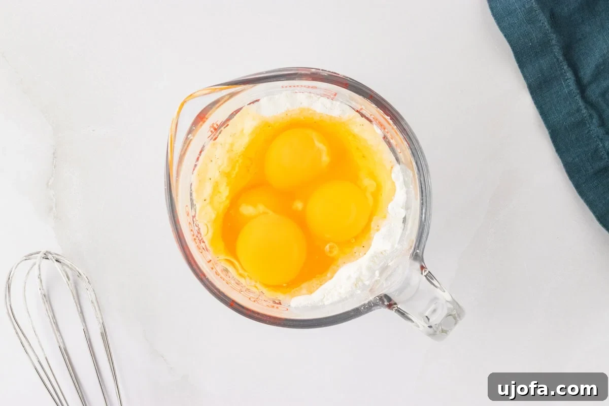 Perfect Gluten-Free Yorkshire Puddings 9 4 eggs over cornstarch in glass measuring cup