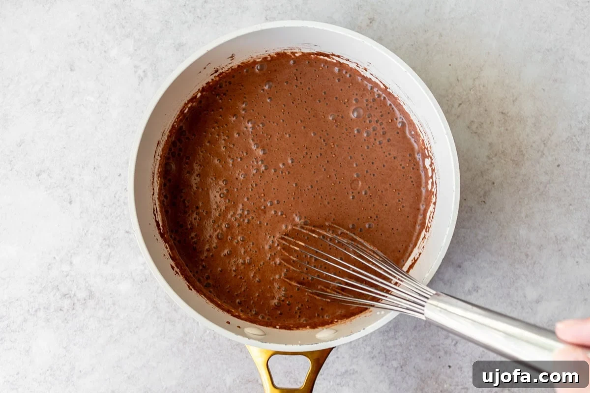 Plant-Based Chocolate Indulgence 7 liquid chocolate in saucepan being whisked