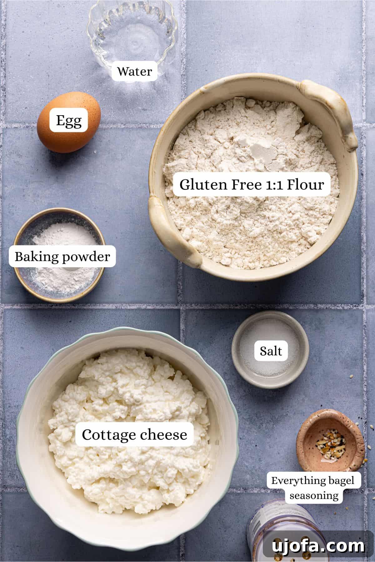 Effortless High Protein Gluten Free Cottage Cheese Bagels 3 Cottage cheese bagels recipe ingredients laid out in nesting bowls and labeled.