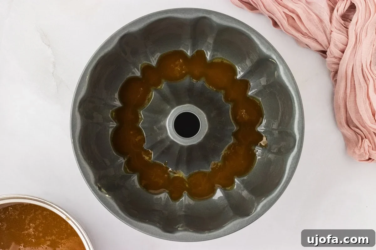 Gooey Gluten-Free Monkey Bread Indulgence 12 A bundt pan with a layer of glistening caramel sauce poured evenly at the bottom.