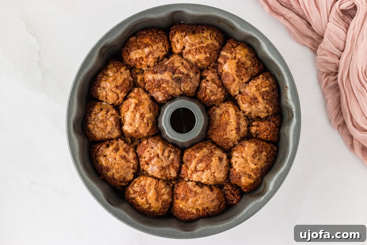 Gooey Gluten-Free Monkey Bread Indulgence 15 A baked gluten-free monkey bread still in its bundt cake pan, showing a golden-brown and caramelized crust.