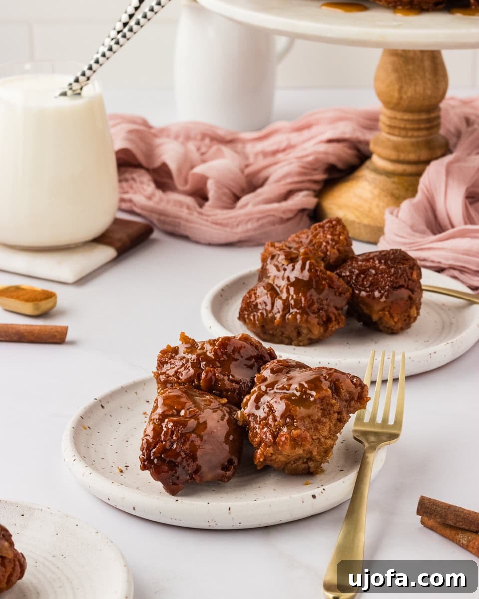 Gooey Gluten-Free Monkey Bread Indulgence 17 Two white plates, each with three delicious pieces of gluten-free monkey bread, ready for serving.