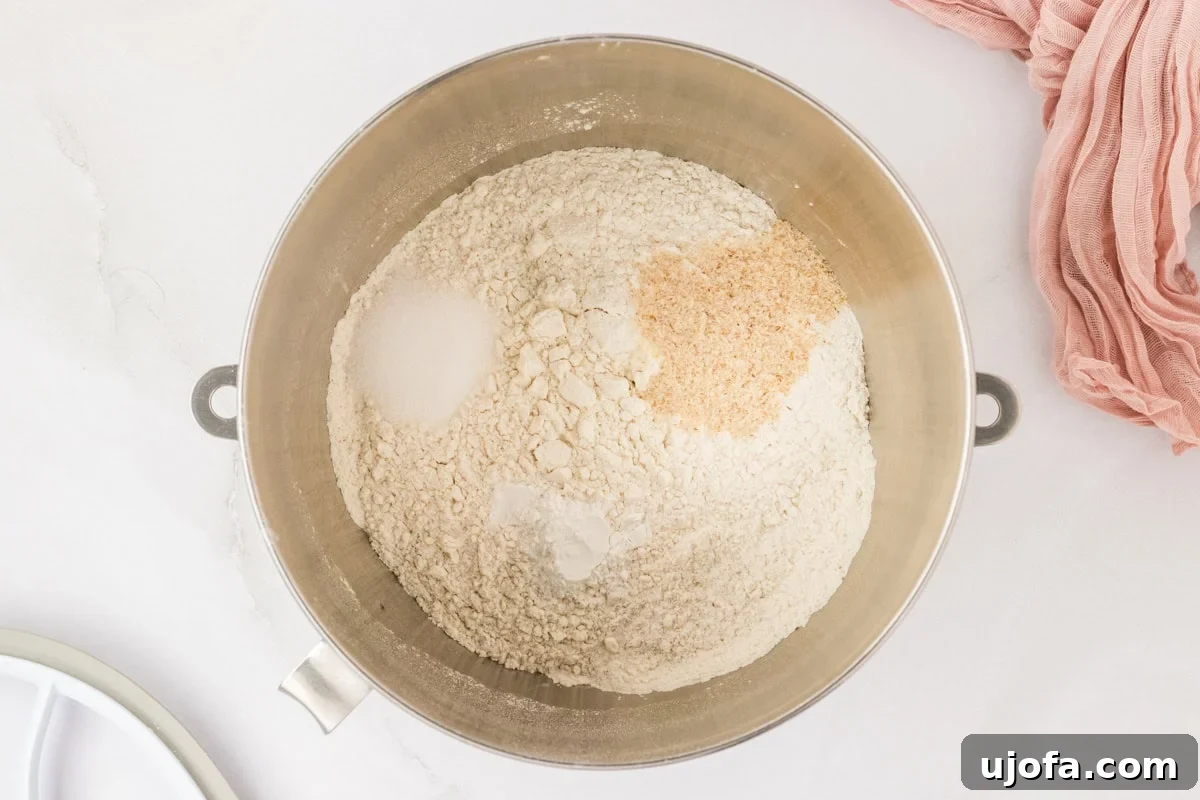 Gooey Gluten-Free Monkey Bread Indulgence 6 A stand mixer bowl containing a mixture of gluten-free flour, sugar, salt, and baking powder, ready for wet ingredients.