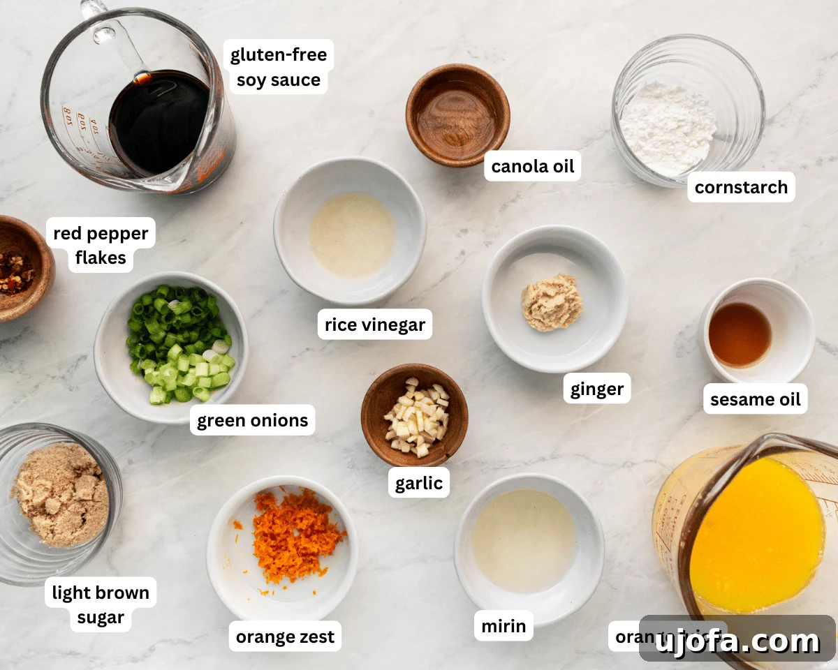 Golden Orange Reduction 3 A vibrant selection of fresh ingredients laid out for orange reduction sauce preparation, including oranges, soy sauce, ginger, garlic, and green onions.