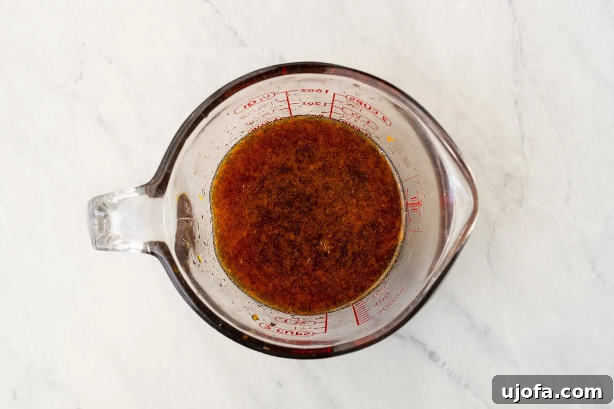 Golden Orange Reduction 8 Overhead view of a glass measuring cup containing the combined soy sauce and orange juice mixture.