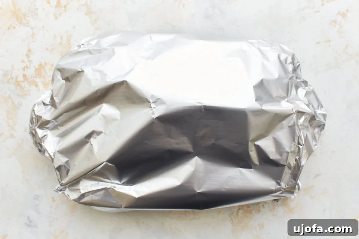 Comforting Gluten-Free Ziti Bake 14 aluminum foil covering baked ziti in baking dish