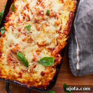 zoomed in picture of gluten-free baked ziti in black baking dish