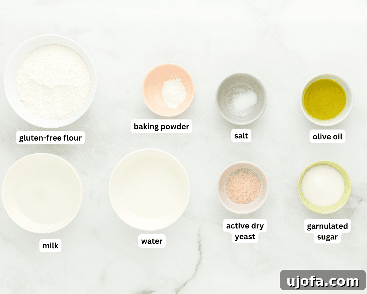 A curated selection of fresh ingredients including gluten-free flour, yeast, milk, and olive oil, laid out for making bao buns.