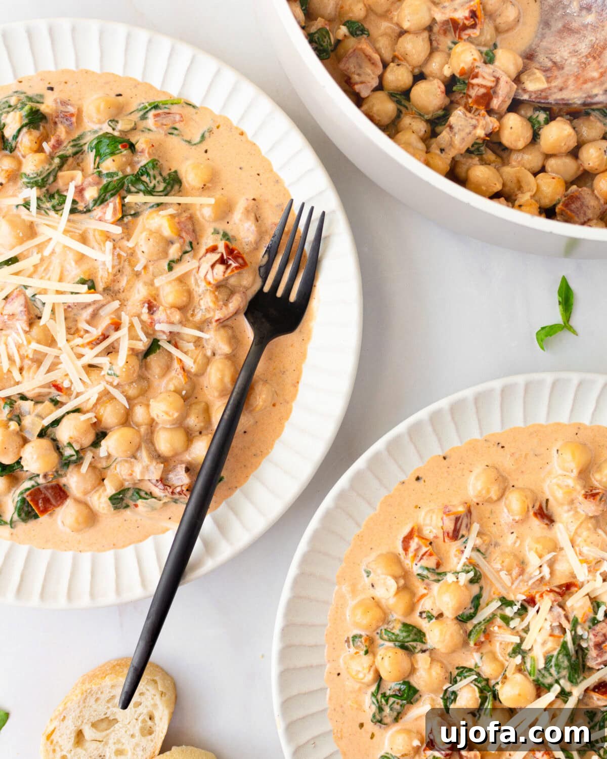 The Hummus Proposal 5 2 white bowls with marry me chickpeas and a black fork resting on the side of one bowl