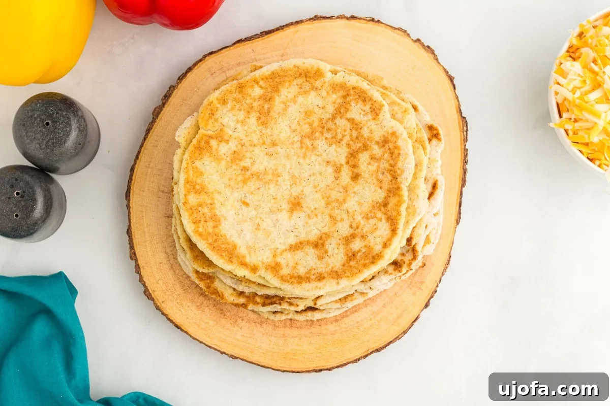 An overhead view of a stack of golden coconut flour tortillas, showcasing their soft and pliable texture.
