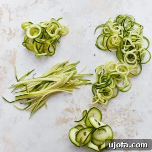 spiralized zucchini noodles, juliened zucchini noodles, and shaved zucchini noodles in piles