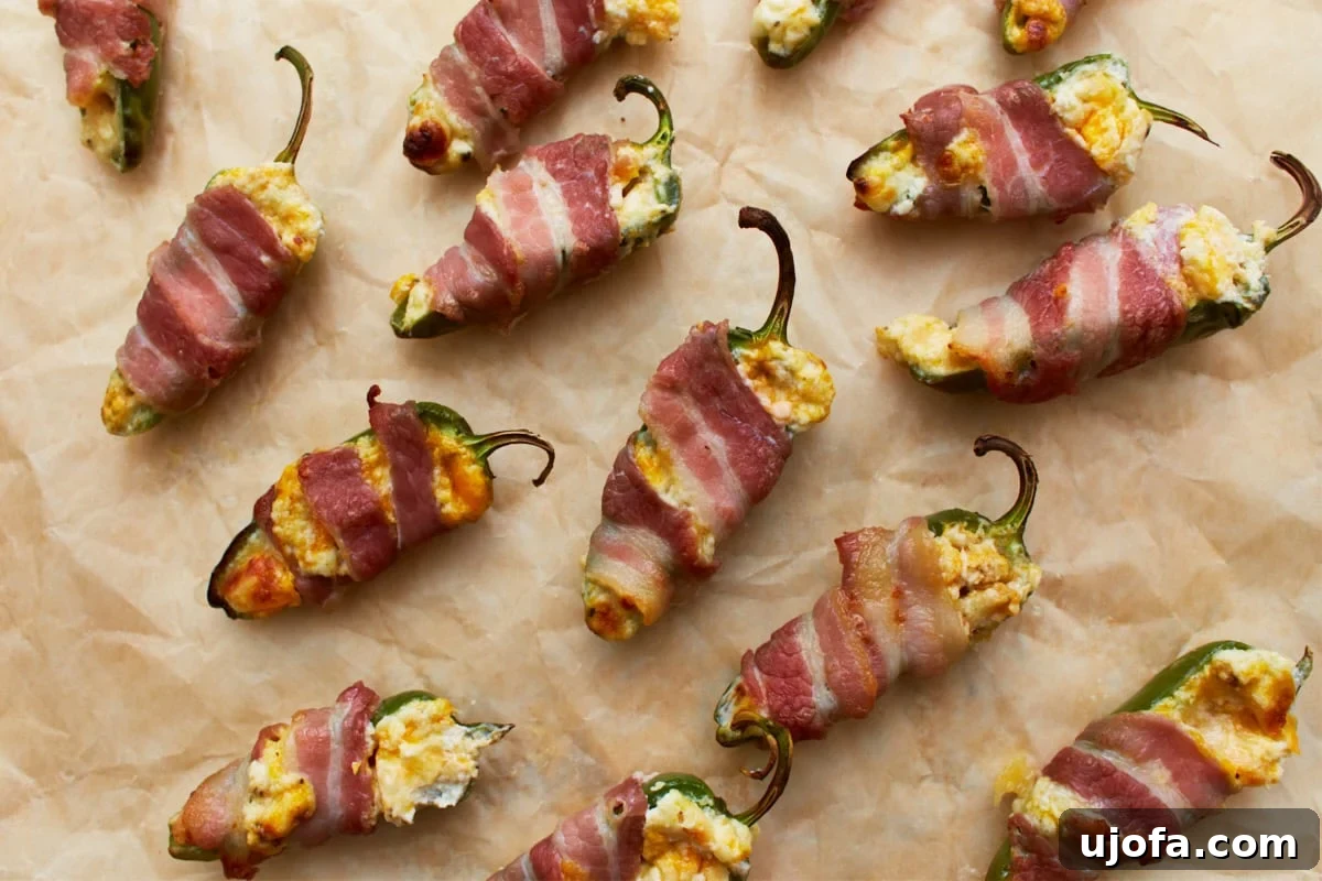 A platter of perfectly baked keto jalapeño poppers, showcasing crispy bacon and melted cheese filling, ready to be enjoyed as a low-carb appetizer.