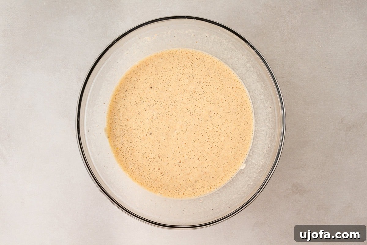 gluten-free batter mixture in a glass mixing bowl, light and airy