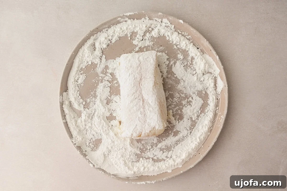 gluten and rice flour coated white fish on a plate with the flour mixture
