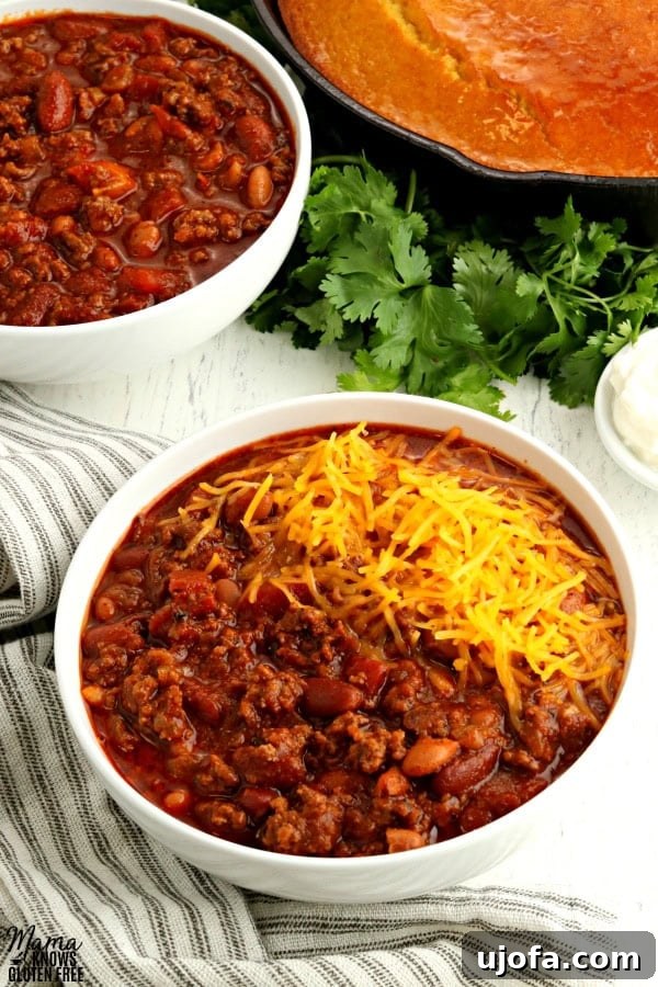 2 bowls of gluten-free chili with cornbread and clintro in the background