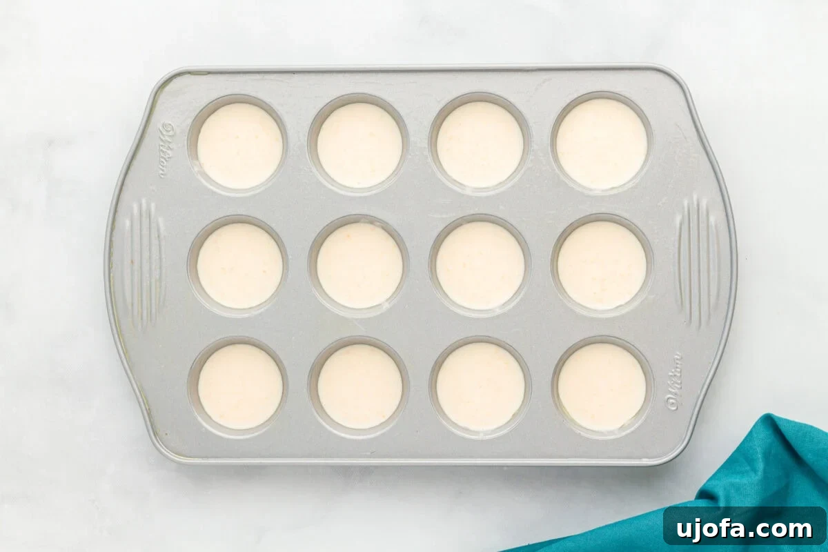 Pão de Queijo batter in a muffin tin