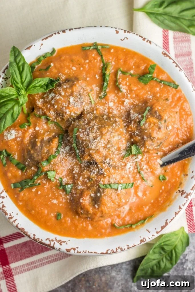 Whole30 Tomato Basil Bisque with Italian Meatballs, a comforting and hearty soup.