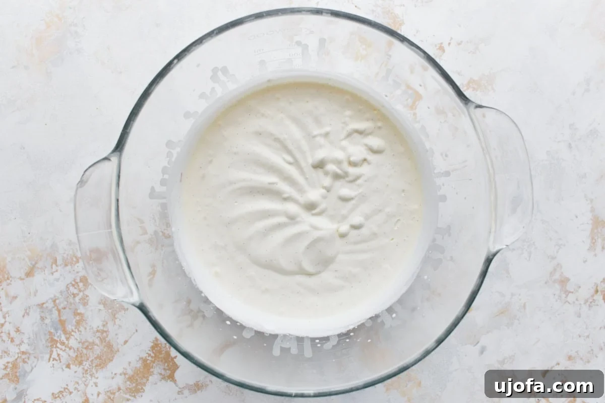 Keto Frozen Delights 7 A clear mixing bowl filled with whipped ice cream base, showing a smooth and creamy texture before freezing.
