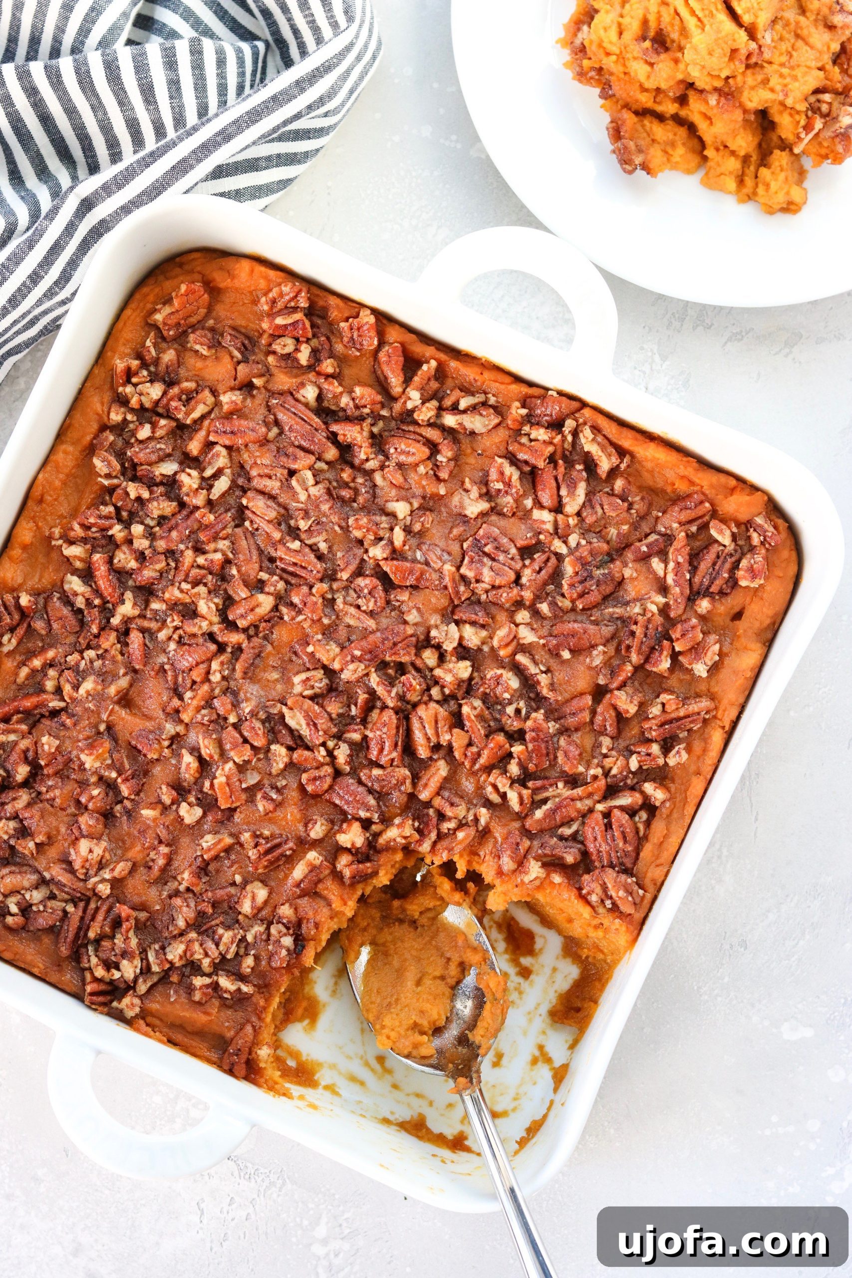 An inviting overhead shot of the finished sweet potato casserole, perfectly baked with a golden, crunchy maple cayenne pecan topping, ready to be served.