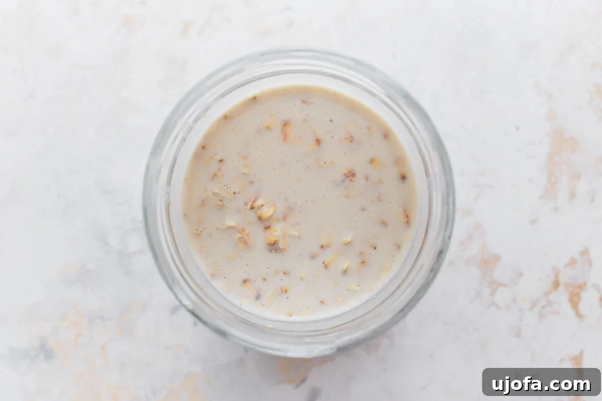 Gluten-Free Overnight Oats: Prep Today, Enjoy Tomorrow 5 A glass jar containing gluten-free overnight oats soaking in creamy liquid, ready to be chilled.