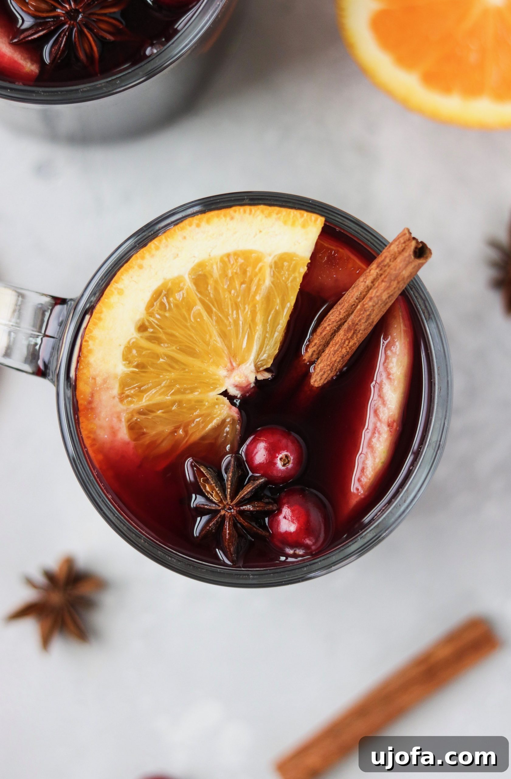 Homemade Mulled Wine: Quick Stovetop or Slow Cooker Simmer 3 Close-up shot of Mulled Wine simmering with fresh orange slices, cinnamon sticks, and star anise.
