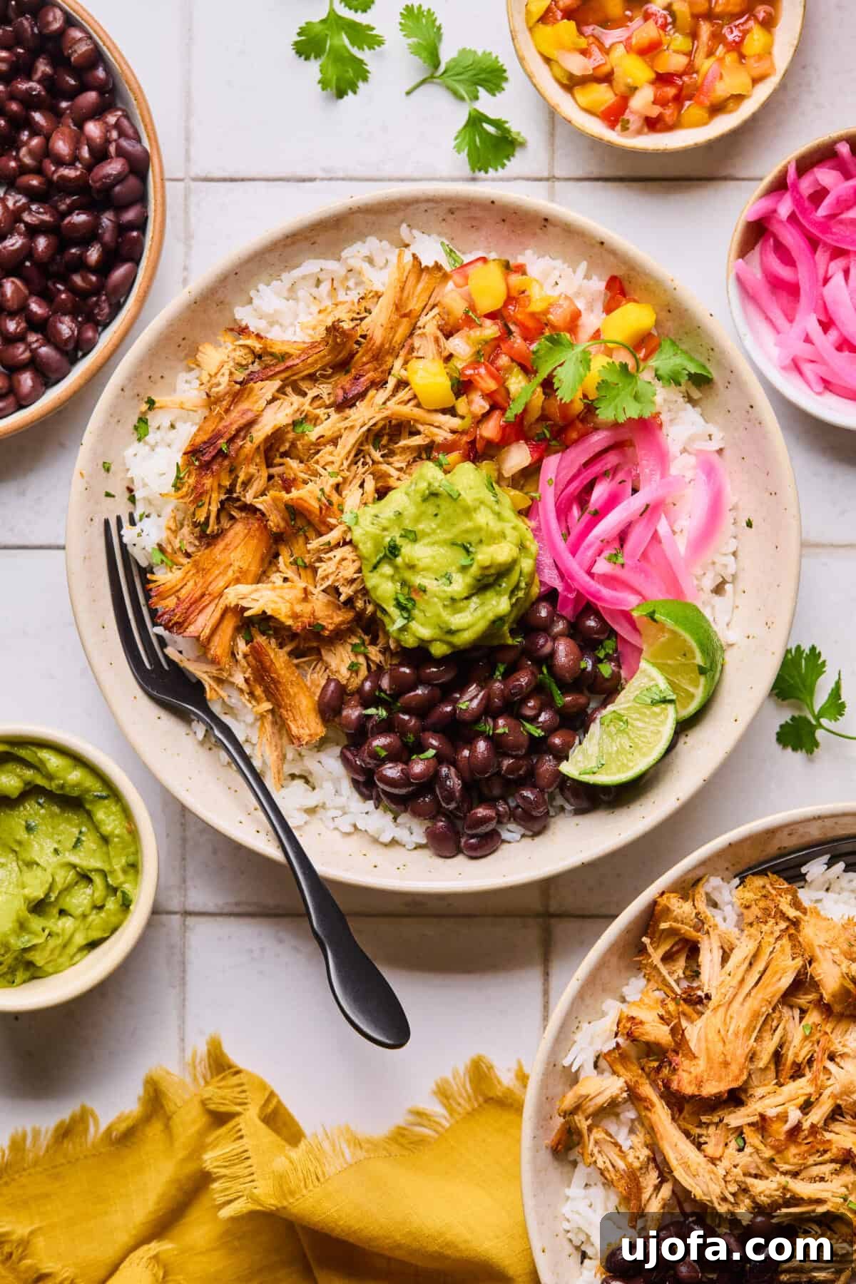 Juicy slow cooker pork carnitas with crispy edges, served in a rustic bowl, garnished with fresh lime wedges and vibrant pickled red onions