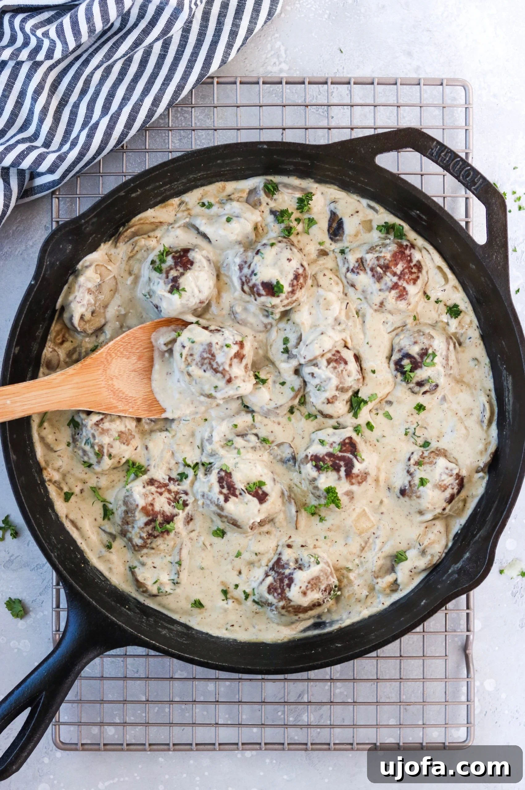 Close-up of Whole30 Meatball Stroganoff simmering in a skillet, showcasing the creamy sauce, mushrooms, and meatballs.