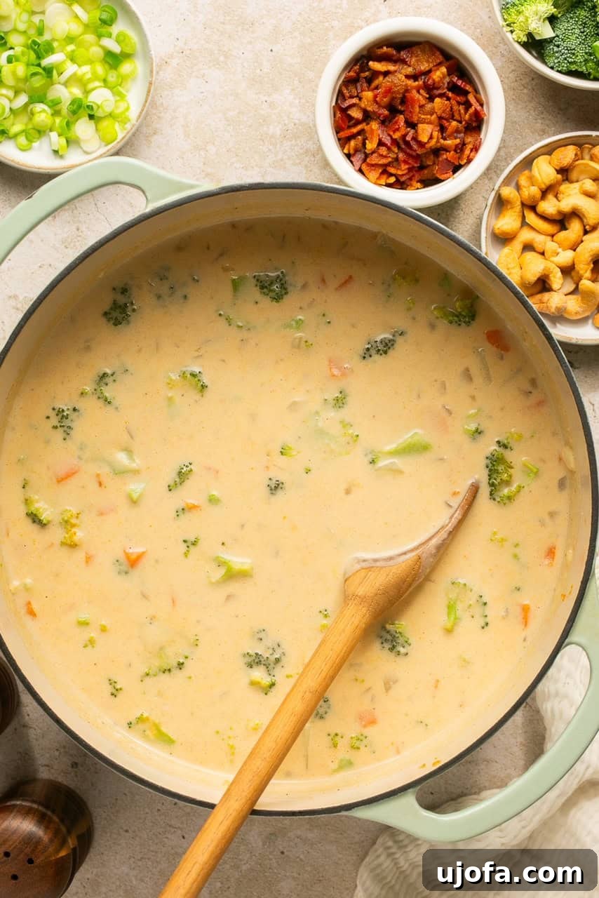An overhead shot of a large pot brimming with perfectly cooked, creamy dairy-free potato soup.
