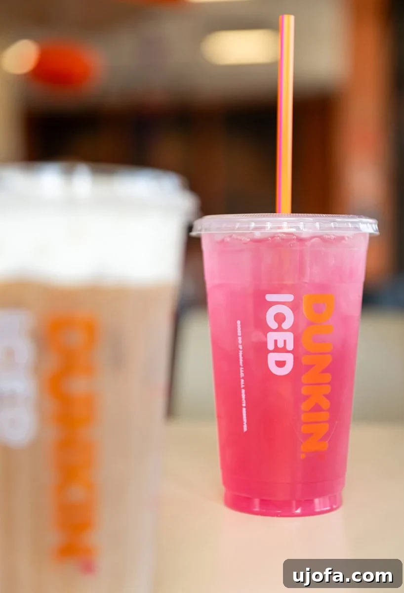 A vibrant Strawberry Dragonfruit Dunkin' Lemonade Refresher, a refreshing gluten-free beverage.
