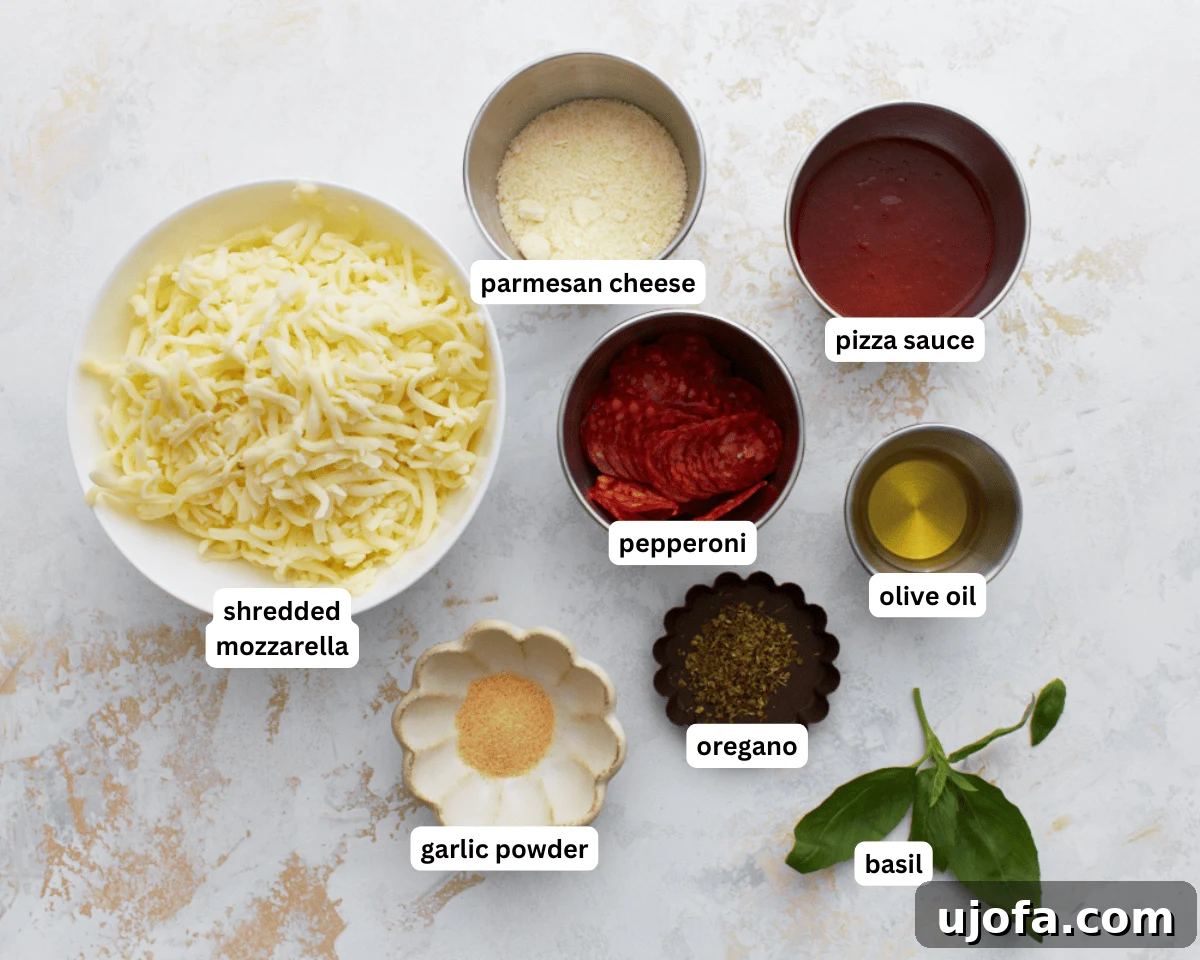 Pizza Bowl 4 Crustless pizza ingredients laid out: olive oil, shredded mozzarella, grated Parmesan, dried oregano, garlic powder, pizza sauce, pepperoni, and fresh basil.