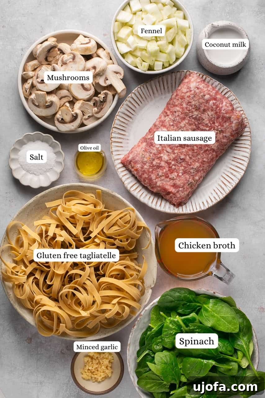 fresh ingredients for fennel and sausage pasta laid out on a cutting board