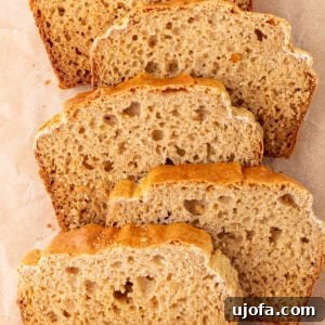 Tropical Root Bread 3 Overhead view of several slices of cassava bread arranged on parchment paper, showing a golden crust and airy crumb.