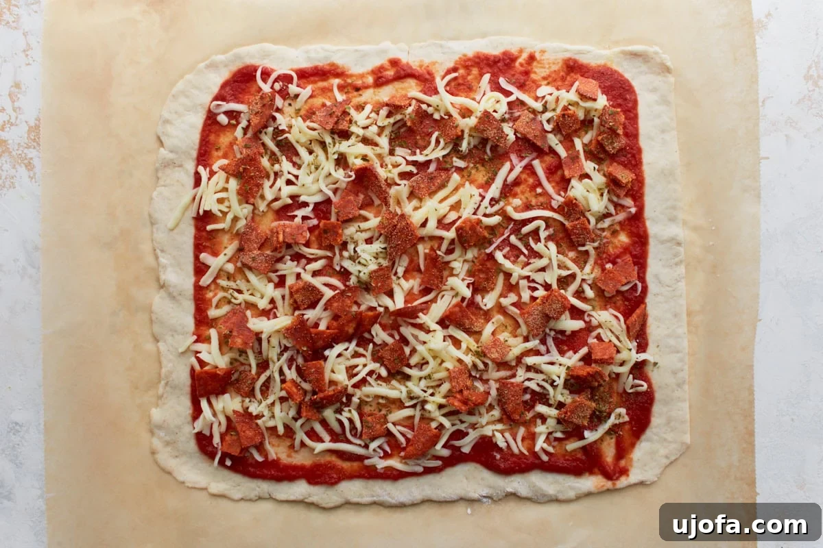 Gluten-free dough covered with a generous layer of shredded mozzarella, diced pepperoni, and aromatic dried herbs over the tomato sauce base.