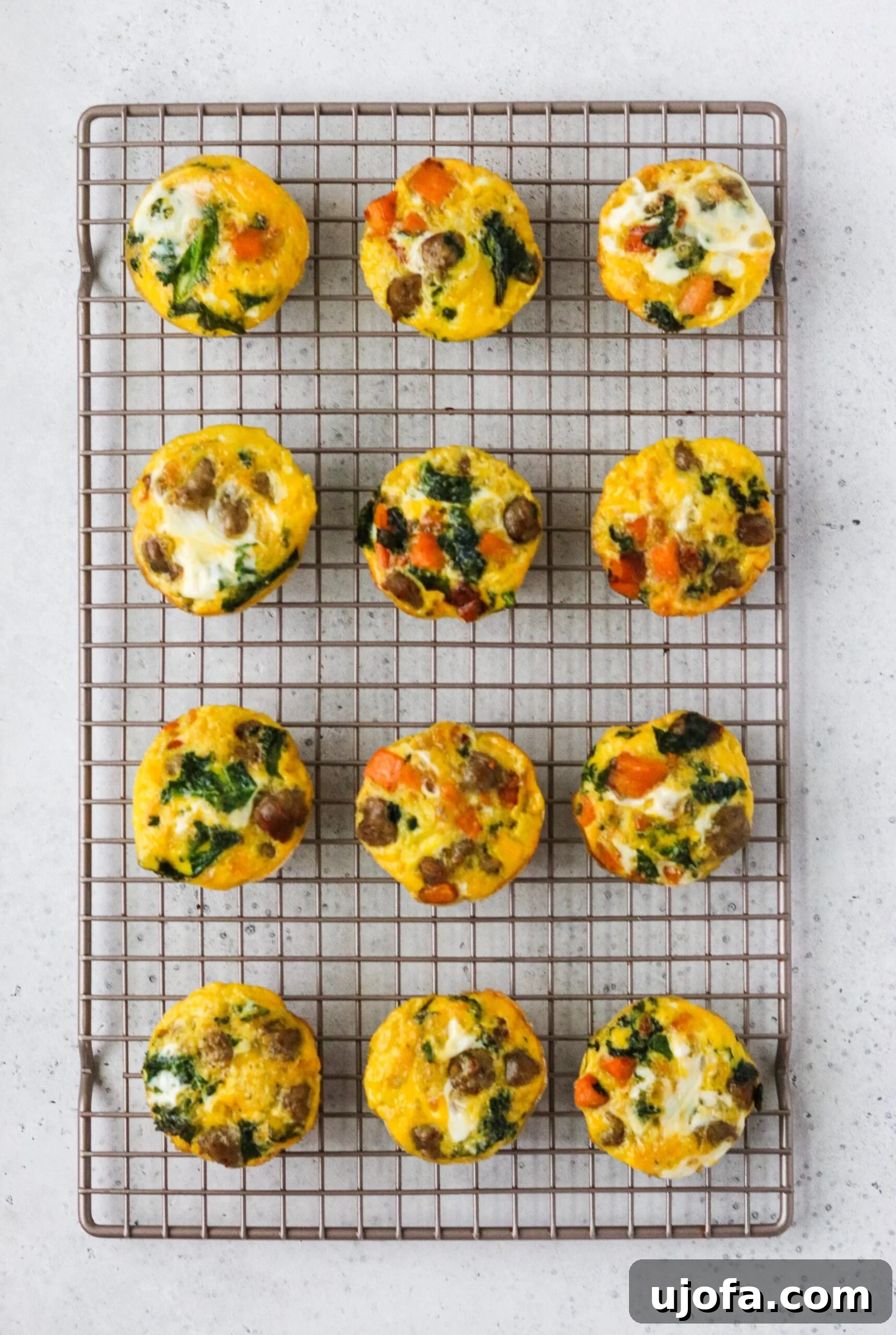 Savory Sausage, Sweet Potato, and Kale Egg Bites Whole30 Paleo 6 Freshly baked sausage, sweet potato, and kale egg cups, golden and perfectly set.