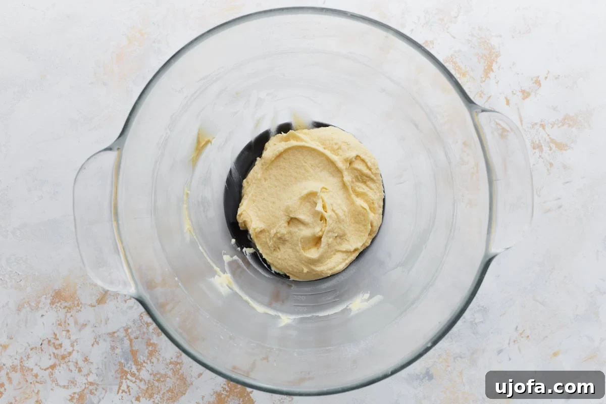 Pure Vanilla Gluten-Free Wafers 6 Wet ingredients fully mixed into a smooth, creamy batter in a glass bowl.