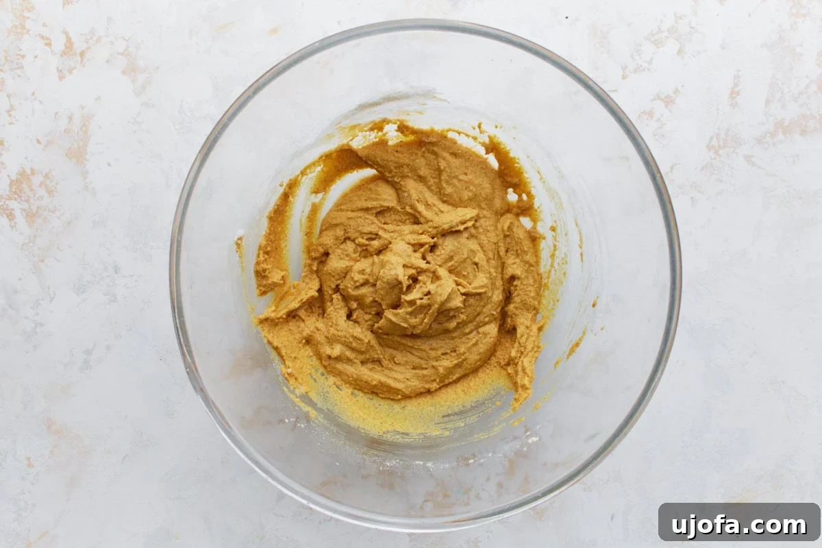 Savory Golden Crisps 6 Thick golden pakora batter in a glass bowl, made from chickpea flour, water, and spices.