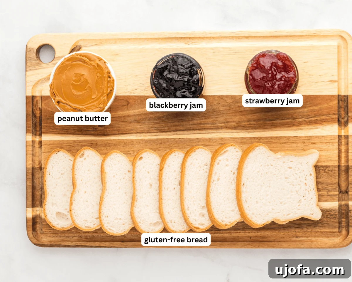 GF Lunchbox Wonders 4 Gluten-free uncrustables ingredients: sliced gluten-free bread, jars of peanut butter and jam, and fresh berries.