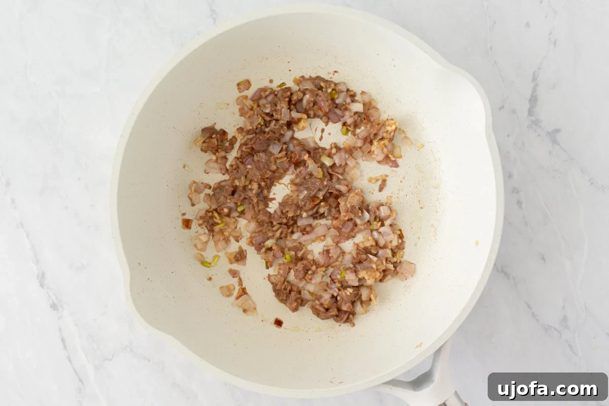 Gluten-Free Worcestershire from Scratch 6 A skillet with softened chopped onions, garlic, ginger, and anchovy paste cooked down into a fragrant base.