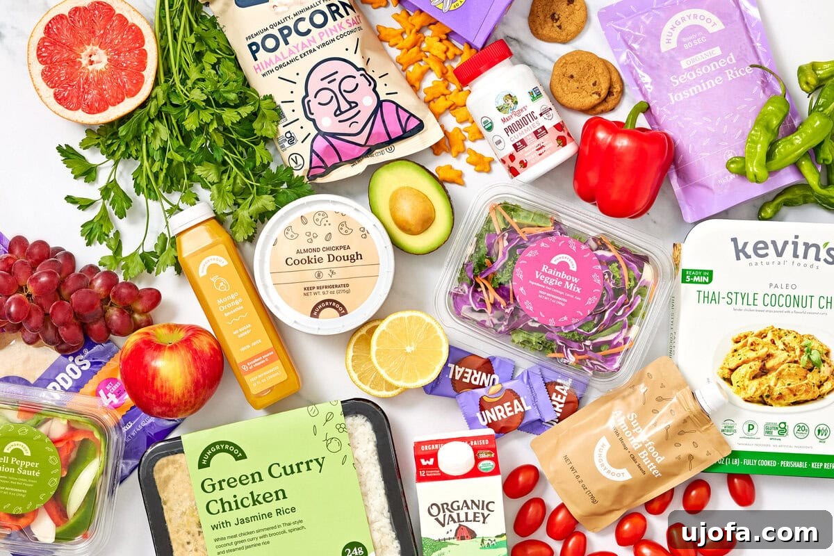 Tangy Tzatziki Black Bean Power Bowl 11 An overhead shot of various Hungry Root products on a white surface, highlighting a range of fresh and convenient ingredients.