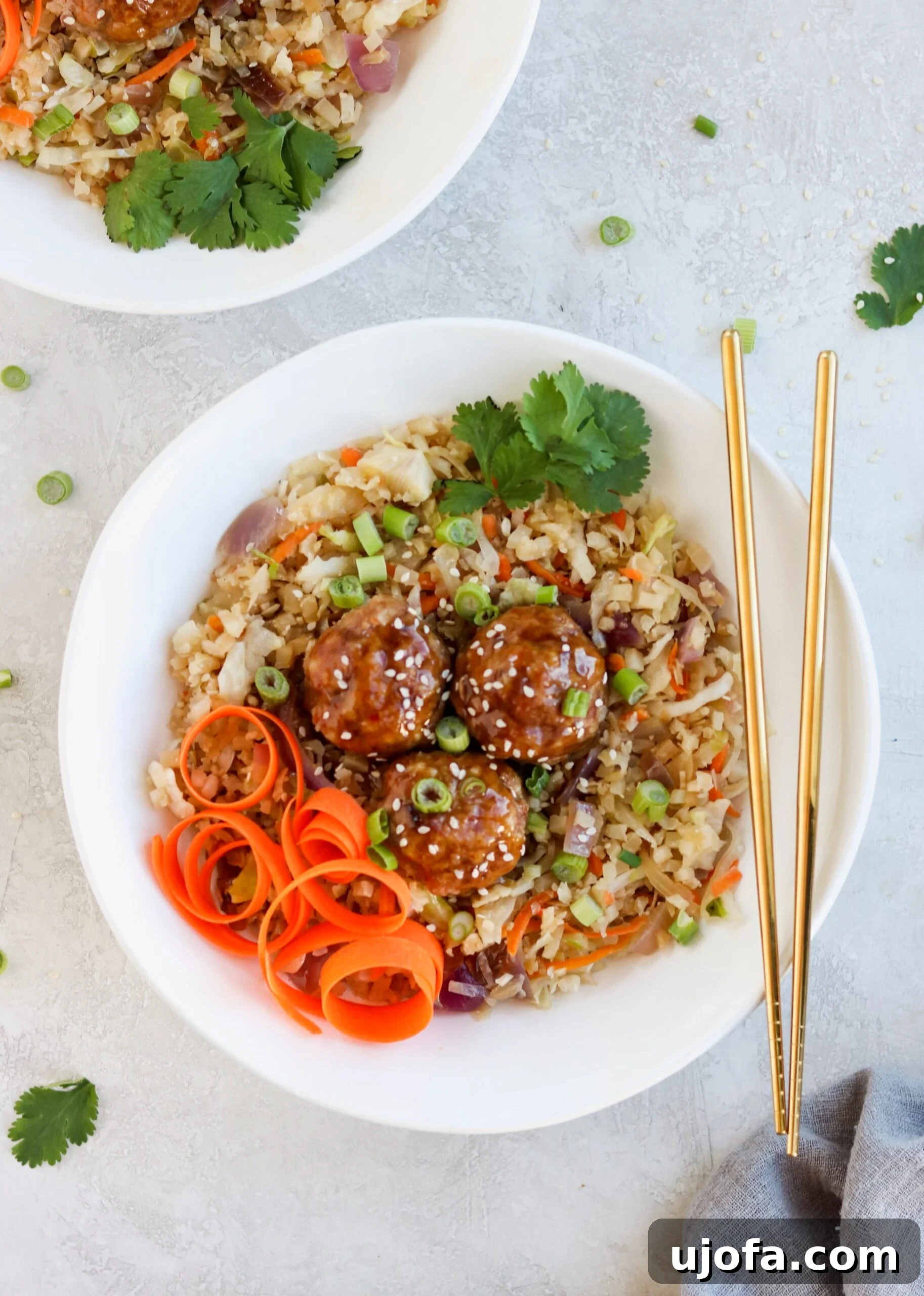 Cooked Asian Pork Meatballs in a skillet with the sticky glaze.