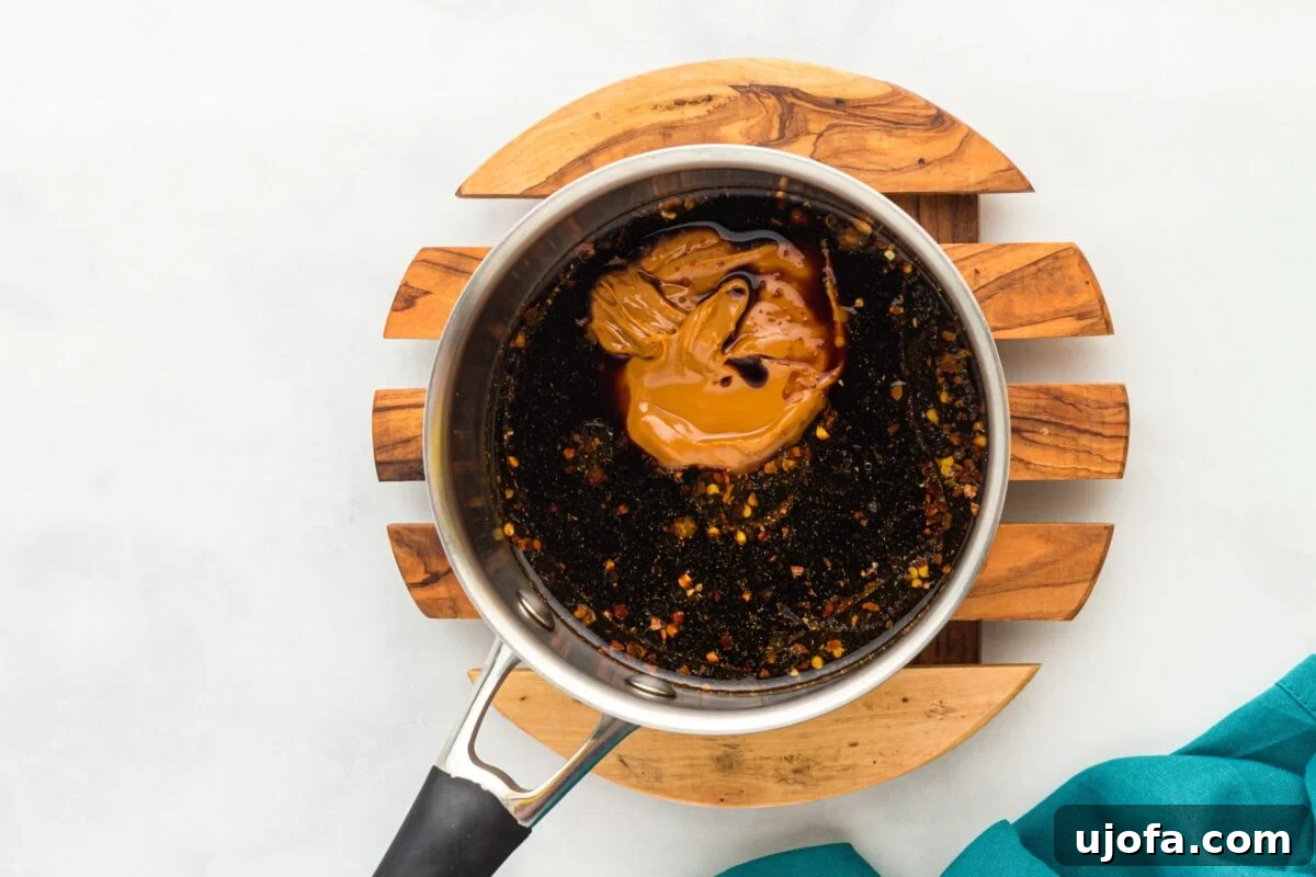 Craft Your Own Gluten-Free Hoisin Sauce 5 Overhead shot of a saucepan with hoisin sauce ingredients, including peanut butter and spices, before being mixed.