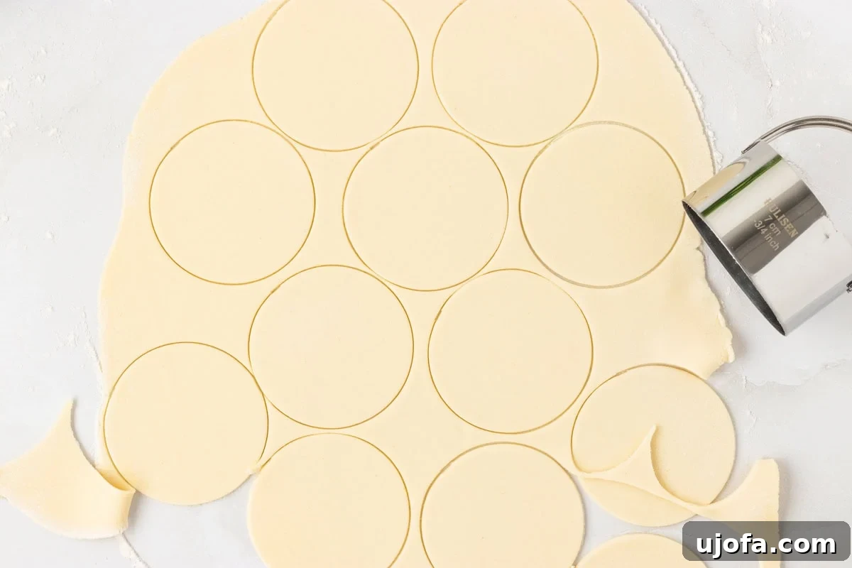 Rolled out sheet of gluten-free pasta dough with evenly cut circles using a round biscuit cutter