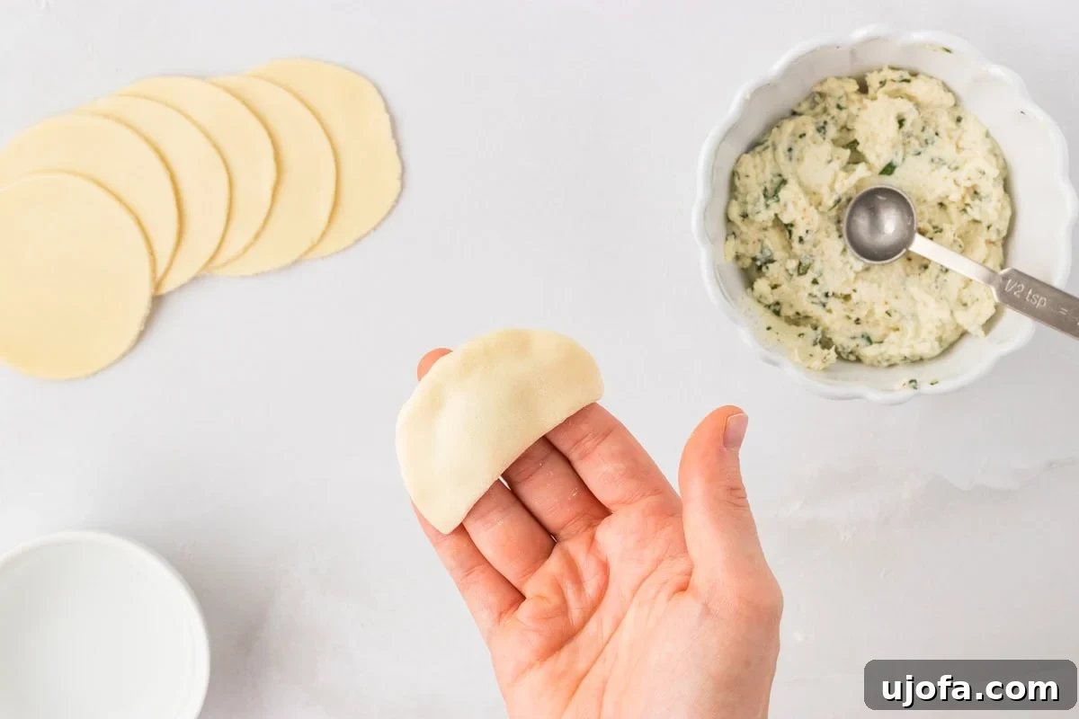 Sealed gluten-free tortellini shaped into a half-moon after pressing edges together