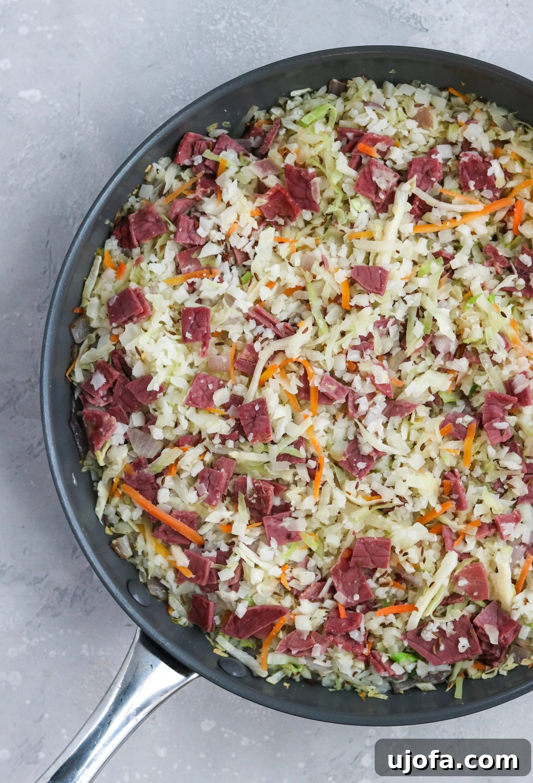 Close-up of a Reuben in a Bowl showing cooked cabbage, cauliflower rice, and generous chunks of corned beef