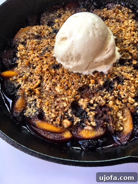 Delicious Peach Berry Crisp Skillet in a cast iron pan, ready to be served